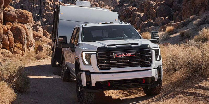 A white GMC Sierra 2500HD near mountains